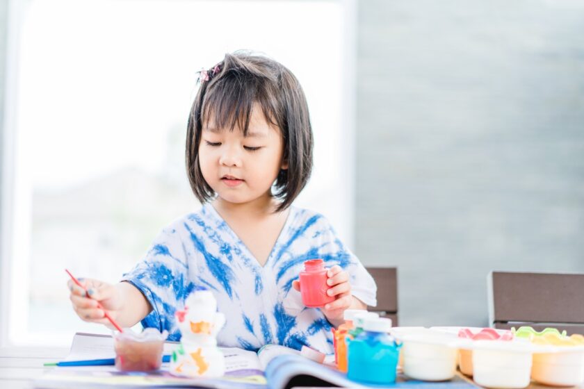 Little girl painting.