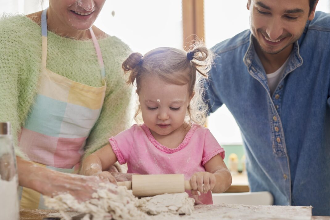 toddler cooking with parents