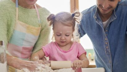 toddler cooking with parents